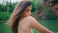 Seductive girl posing topless portrait. Sexy woman looking over shoulder at lake Royalty Free Stock Photo