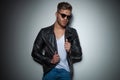 Seductive man with sunglasses holding his jacket collar Royalty Free Stock Photo