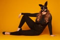 Seductive plus-size girl in bunny mask posing on the floor