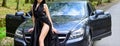 Seductive pose. Sex in car. Driver girl. Beauty and fashion. Woman in black dress escort service worker. Sexy girl Royalty Free Stock Photo