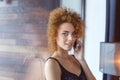 Seductive relaxed young woman talking on mobile phone Royalty Free Stock Photo