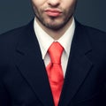 Seductive smile of a young handsome man businessman in classic black suit, white shirt with trendy pink tie. Close up. Studio Royalty Free Stock Photo