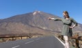 Seductive white caucasian tourist woman, hitch hiker in the volcano of el Teide, Tenerife, with a green dress. Excited independent Royalty Free Stock Photo