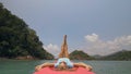 Seductive woman lifts up long legs lying on canoe on sea Royalty Free Stock Photo