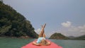 Seductive woman lifts up long legs lying on canoe on sea Royalty Free Stock Photo