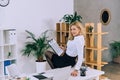 seductive woman sitting on table with documents and looking Royalty Free Stock Photo