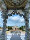 See through an artistic arch of a Hindu temple.