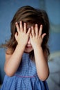 See no evil girl. Baby 3 years covers eyes with hands
