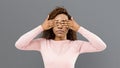 Portrait of young scared woman covering eyes with both hands Royalty Free Stock Photo