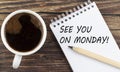 SEE YOU ON MONDAY text on notebook with coffee on the wooden background