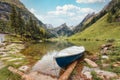 Seealpsee mountain lake and boat in Alpstein mountain range at Switzerland