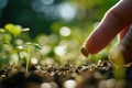 Seed resting on a fingertip against a blurred green background, symbolizing nature and potential growth