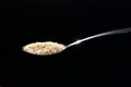 Seed of white sesame, organic ingredient on spoon isolated on black background Royalty Free Stock Photo