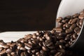 Seeds of coffee in a black cup on a wooden background Royalty Free Stock Photo