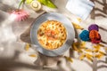 Seefood pasta with cream sauce and raw tomato in a bowl isolated on background side view