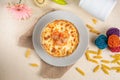 Seefood pasta with cream sauce and raw tomato in a bowl isolated on background side view