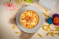 Seefood pasta with cream sauce and raw tomato in a bowl isolated on background side view