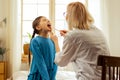 Female otolaryngologist examining throat of small cute ill girl Royalty Free Stock Photo