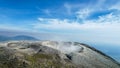 Seeing the inside of a volcano crater with smoke in east Java, Indonesia. Aerial view of volcano crater Mount Sindoro. West Java, Royalty Free Stock Photo