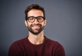 Seeing things in a positive light. Studio shot of a handsome and happy young man posing against a gray background. Royalty Free Stock Photo