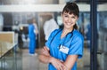 Seeing you healthy makes me smile. Portrait of a confident young doctor working in a hospital with her colleagues in the