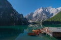 The Seekofel mountains and wooden boats reflected in the waters of Lake Braies
