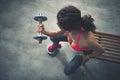 Seen from above fitness woman lifting dumbbell