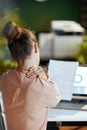Seen from behind modern business woman having neck pain Royalty Free Stock Photo