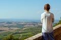 Seen from behind trendy solo tourist woman in Tuscany, Italy