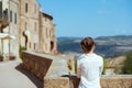 Seen from behind trendy solo traveller woman in Tuscany, Italy