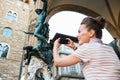 Seen from behind woman taking photo of statue of Perseus, Italy