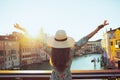 Seen from behind young solo traveller woman in floral dress