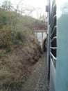 Seen of train running between stone mountains and going out from tunnel Royalty Free Stock Photo