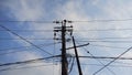 Seen from under an electricity pole with a complicated cable arrangement. Selective focus. Wide view Royalty Free Stock Photo