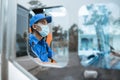 seen from the window of a male driver in a uniform and wearing a mask while behind the wheel Royalty Free Stock Photo