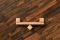Seesaw made of wooden blocks symbolizing balance - 3D rendered illustration