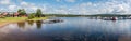 Segersta, Halsingland , Sweden - Extra large panoramic view over a camping with reflecting calm water and small red wooden