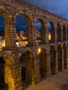 Segovia, Spain at the ancient Roman aqueduct. The Aqueduct of Segovia, located in Plaza del Azoguejo, is the defining historical f