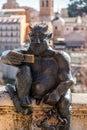 Devil statue taking a selfie against the ancient Roman aqueduct of Segovia, Spain