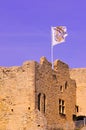 Seguret building ruins, flying a fighting flag, against a blue sky