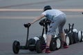 Segway rental. Happy young girl choosing segways at the box office on the street