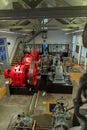 View of a classic 1934 industrial hydroelectric generators turbine and engine, on machine room inside an exhibition hall at the Royalty Free Stock Photo