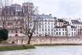Seine river, houses, relaxing people and coast of Paris.