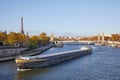 Seine river view with barge, Eiffel tower and Alexander III bridge in a sunny autumn day in Paris Royalty Free Stock Photo