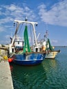 Seiner fishing ships with equipment in the port of Porto Lagos under blue sky with clouds