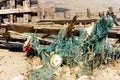 Seines or trawls or fishnets stuck on the old wooden keel of shipwreck that lay on the beach