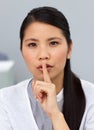 Seious asian businesswoman asking for silence