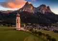 Seis am Schlern, Italy - St. Valentin Church and famous Mount Sciliar mountain with colorful clouds, blue sky and warm sunlight