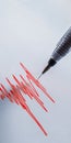 A seismograph pen records vibrations on paper, capturing data about the earthquake. The graph displays sharp amplitude