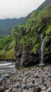 Seixal, Portugal, Europe, Atlantic Ocean and black sand beach, stunning waterfall, stones Royalty Free Stock Photo